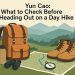 Day hiking essentials packed in a backpack on a trail, ready for an outdoor adventure